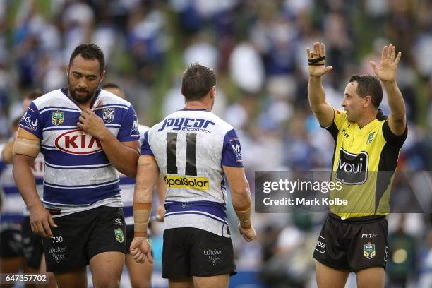 Sam Kasiano of the Bulldogs looks dejected as he is given 10 minutes in the sin bin by referee Gerard Sutton for fighting during the round one NRL...