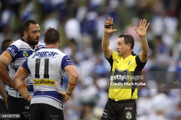 Sam Kasiano of the Bulldogs looks dejected as he is given 10 minutes in the sin bin by referee Gerard Sutton for fighting during the round one NRL...