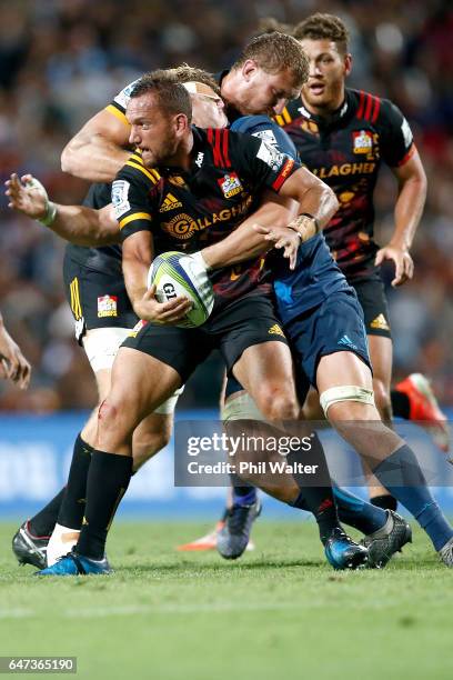 Aaron Cruden of the Chiefs is tackled during the round two Super Rugby match between the Chiefs and the Blues at Rugby Park on March 3, 2017 in...