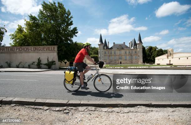 Chateau Pichon Longueville Pauillac France, A man cycling past this historic French wine estate in the Pauillac region of Bordeaux France.