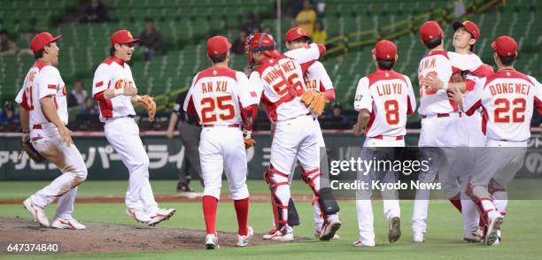 China players celebrate after defeating Brazil 5-2 in their World Baseball Classic first-round Pool A game at Yafuoku Dome in Fukuoka, Japan, on...