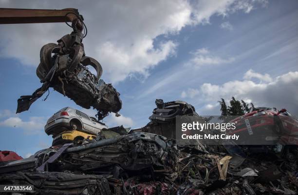 Crushed scrap car is loaded by crane onto a lorry at Pylle Motor Spares and Metal Processing, a licensed scrap yard in Pylle, near Shepton Mallet on...