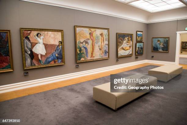 Gallery interior inside with framed paintings mounted on wall, Kode 3 art gallery Bergen, Norway.