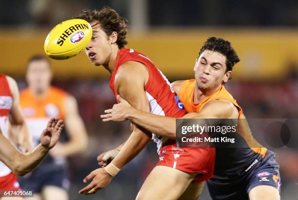 Oliver Florent of the Swans is challenged by Tim Taranto of the Giants during the 2017 JLT Community Series AFL match between the Greater Western...