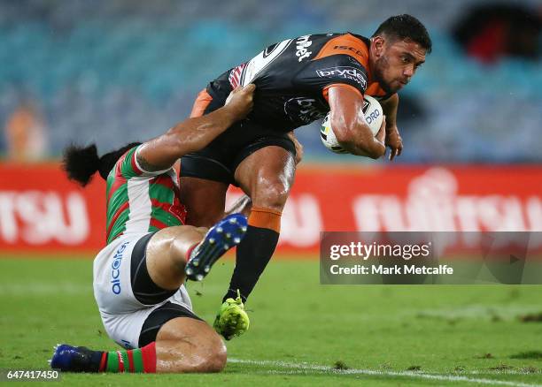 David Nofoaluma of the Tigers is tackled by Siosifa Talakai of the Rabbitohs during the round one NRL match between the South Sydney Rabbitohs and...