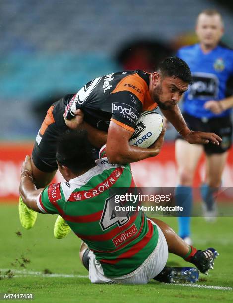 David Nofoaluma of the Tigers is tackled by Siosifa Talakai of the Rabbitohs during the round one NRL match between the South Sydney Rabbitohs and...