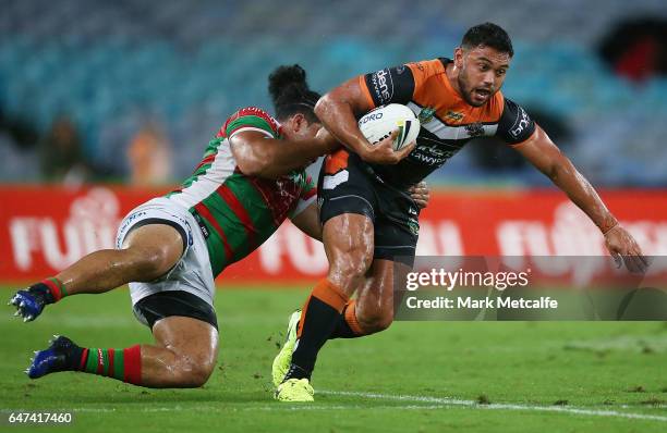 David Nofoaluma of the Tigers is tackled by Siosifa Talakai of the Rabbitohs during the round one NRL match between the South Sydney Rabbitohs and...