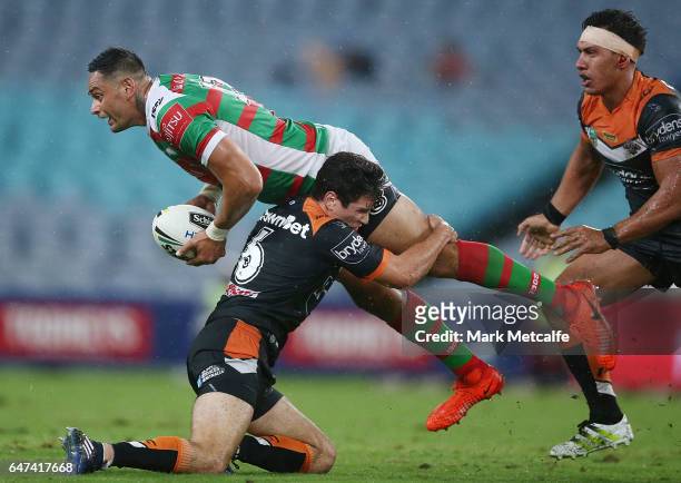 John Sutton of the Rabbitohs passes as he is tackled by Mitch Moses during the round one NRL match between the South Sydney Rabbitohs and the Wests...