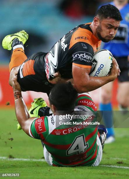 David Nofoaluma of the Tigers is tackled by Siosifa Talakai of the Rabbitohs during the round one NRL match between the South Sydney Rabbitohs and...