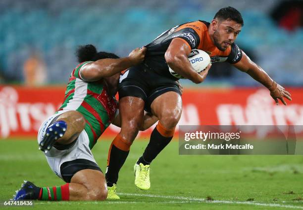 David Nofoaluma of the Tigers is tackled by Siosifa Talakai of the Rabbitohs during the round one NRL match between the South Sydney Rabbitohs and...