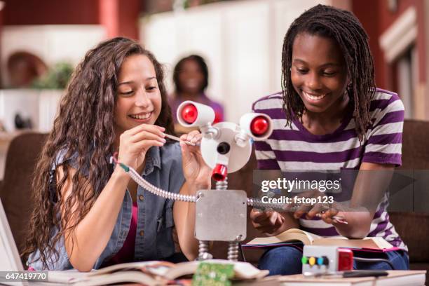 middelbare schoolmeisjes werken op robot voor onderwijs, wetenschap-project voor procestechniek. - child with robot stockfoto's en -beelden
