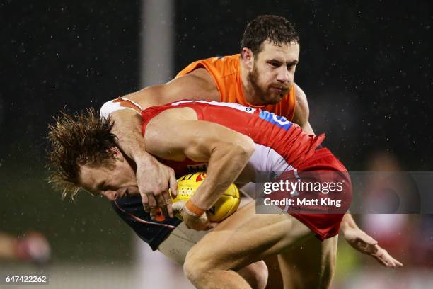 Callum Mills of the Swans is tackled high by Shane Mumford of the Giants during the 2017 JLT Community Series AFL match between the Greater Western...