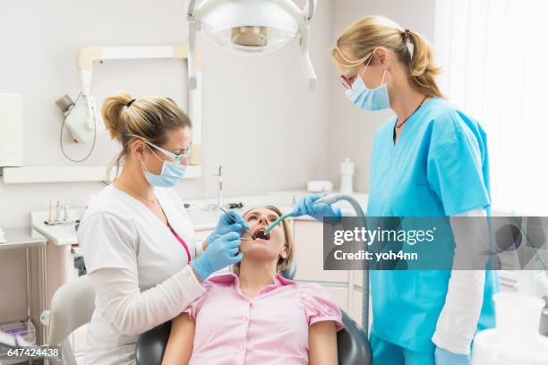 patient & dental team - suction tube stock pictures, royalty-free photos & images