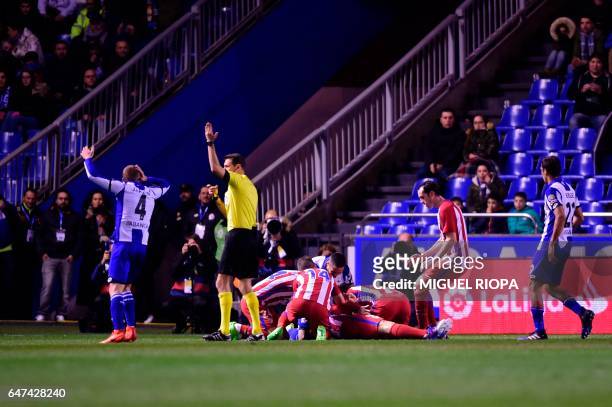 Referee calls for medical assistance after Atletico Madrid's forward Fernando Torres got an injury during the Spanish league football match RC...