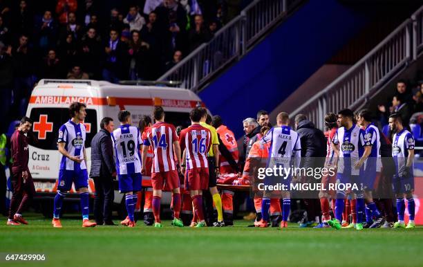 Atletico Madrid's forward Fernando Torres is stretched out after colliding with Deportivo La Coruna's midfielder Alex Bergantinos during the Spanish...