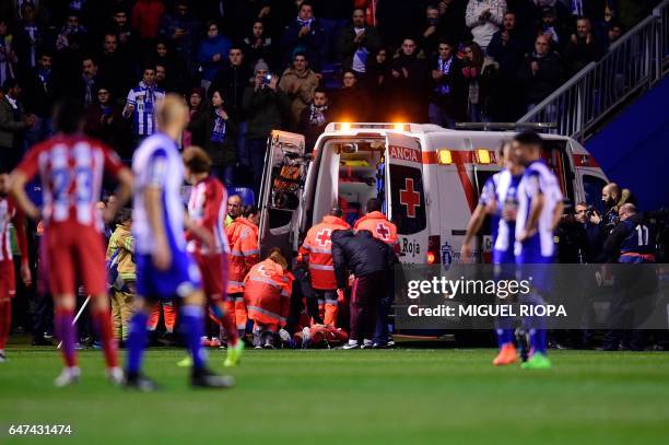 Atletico Madrid's forward Fernando Torres is evauated in an ambulance after colliding with Deportivo La Coruna's midfielder Alex Bergantinos during...