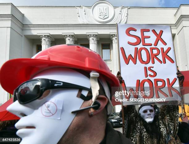 Sex workers wearing masks demonstrate in front of Ukrainian parliament during a "March of the sex workers" in Kiev on March 3, 2017. For the first...