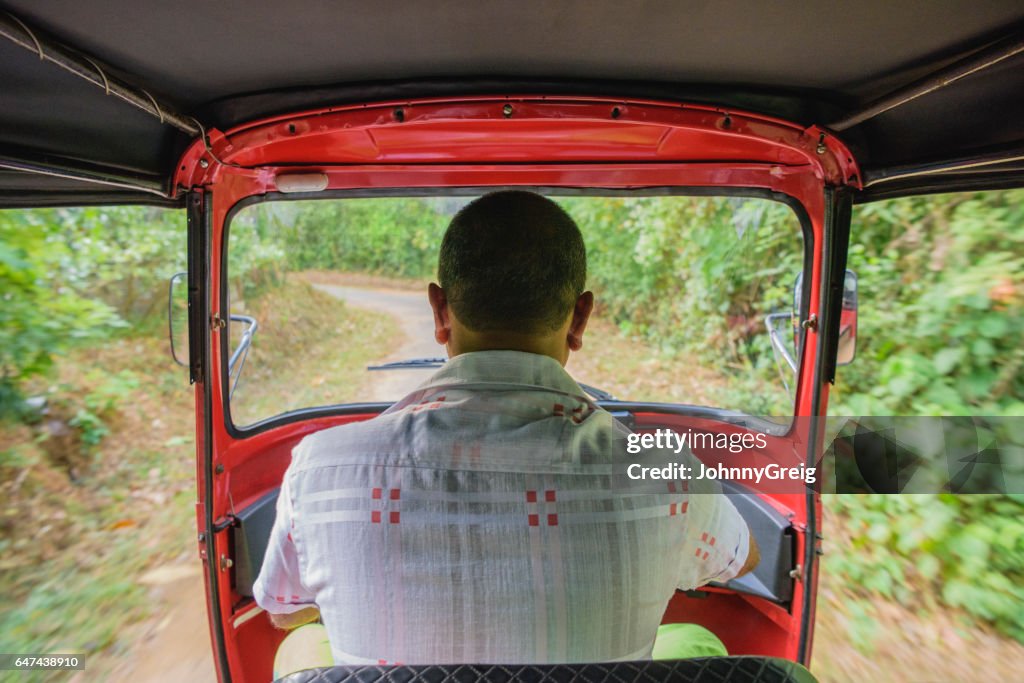 Rear view of man driving rickshaw, Sri Lanka