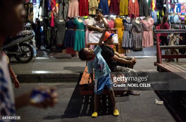 Boy takes a selfie in Divisoria market in Manila on March 3, 2017.