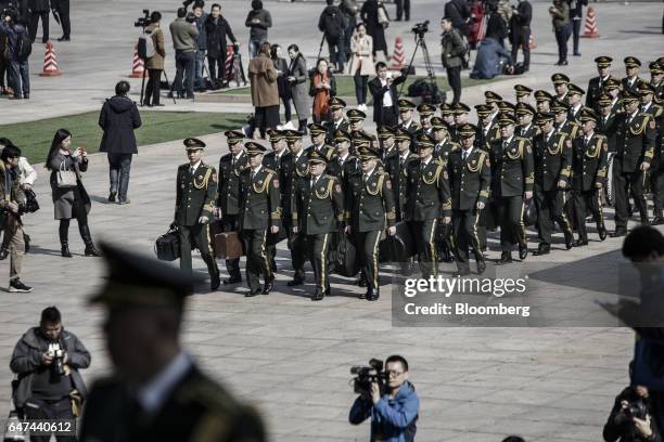 Members of the Chinese People's Liberation Army band arrive ahead of the opening ceremony of the fifth session of the 12th Chinese People's Political...