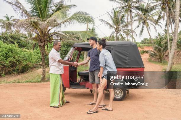 two backpackers with rickshaw driver, man shaking his hand - gap year stock pictures, royalty-free photos & images