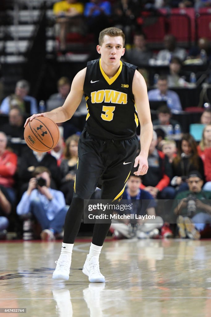 Jordan Bohannon of the Iowa Hawkeyes dribbles the ball during a