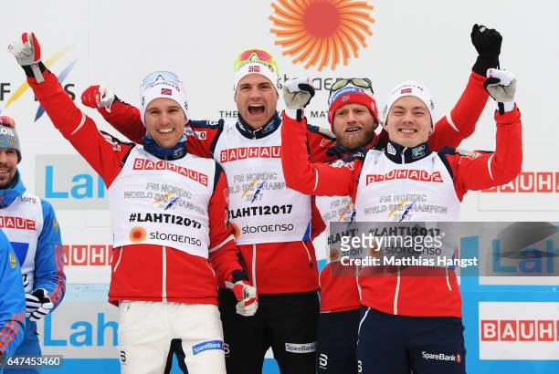 Finn Haagen Krogh, Didrik Toenseth, Niklas Dyrhaug and Martin Johnsrud Sundby of Norway celebrate winning the gold medal in the flower ceremony for...