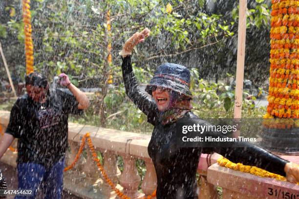 Holi Festival 2010 - Water Wastage - Hiranandani residents dance in the rain Dance on holi at Powai on Monday.