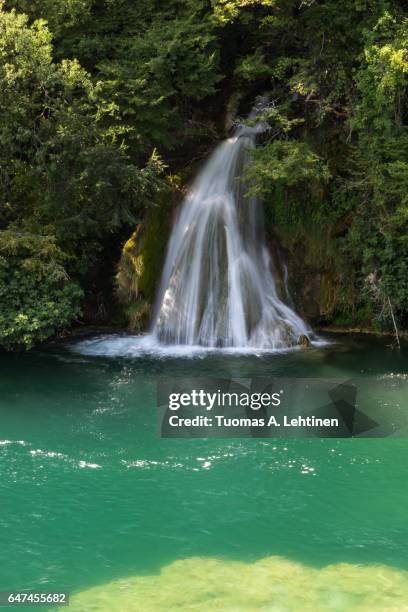 small waterfall and a pond at the krka national park in croatia, on a sunny day. - small waterfall stock pictures, royalty-free photos & images