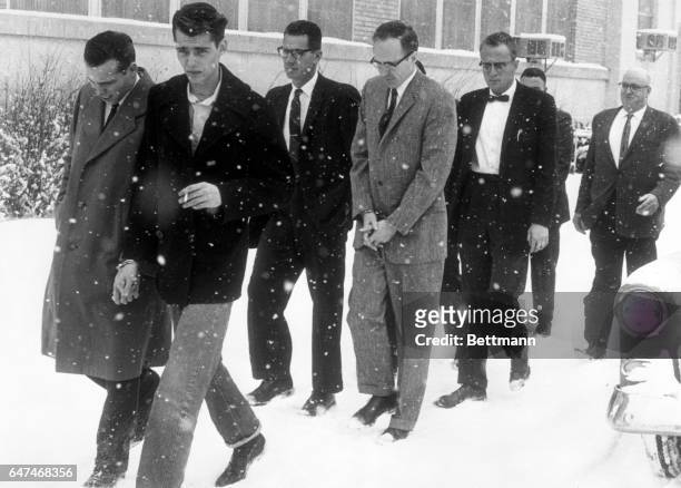 Joseph Corbett Jr., , accused kidnap-slayer of Colorado brewer Adolph Coors III, walks handcuffed, with a group of prisoners back to his jail cell...