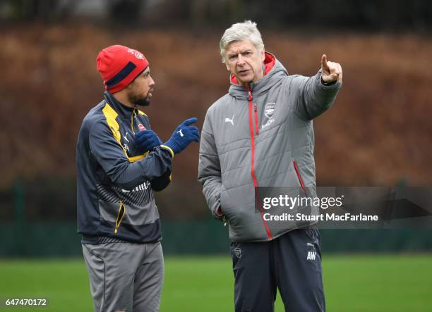 Arsenal manager Arsene Wenger talks with Francis Coquelin during a training session at London Colney on March 3, 2017 in St Albans, England.