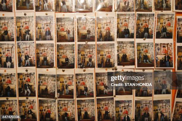 Wall of photographs of visitors taken by Elvis Presley fan Paul MacLeod at "Graceland Too", a vast collection of Presley related items, 17 August...