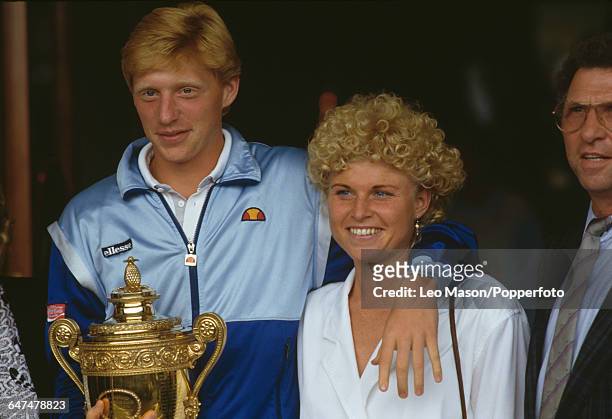German tennis player Boris Becker pictured holding the Gentlemen's Singles Challenge CupTrophy with his sister Sabine and father Karl-Heinz Becker...