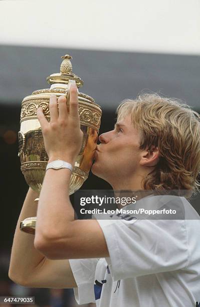 Swedish tennis player Stefan Edberg kisses the Gentlemen's Singles Challenge Cup Trophy after defeating Boris Becker in the final of the Men's...