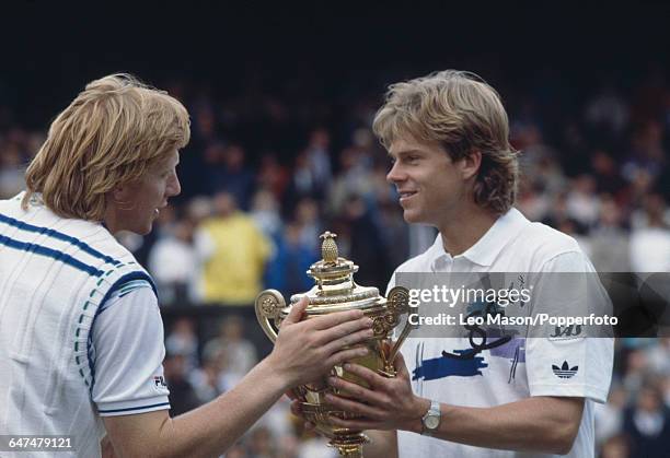 Swedish tennis player Stefan Edberg holds up the Gentlemen's Singles Challenge CupTrophy for Boris Becker to touch after Edberg defeated Becker in...