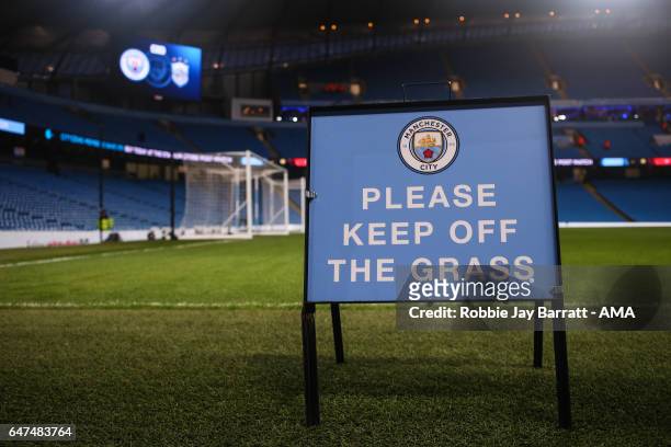 Signage at Etihad Stadium, home stadium of Manchester City reads Please Keep Off The Grass during The Emirates FA Cup Fifth Round Replay between...