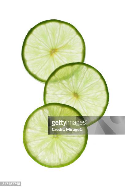 illuminated lime slices - doorsnede lemon stockfoto's en -beelden