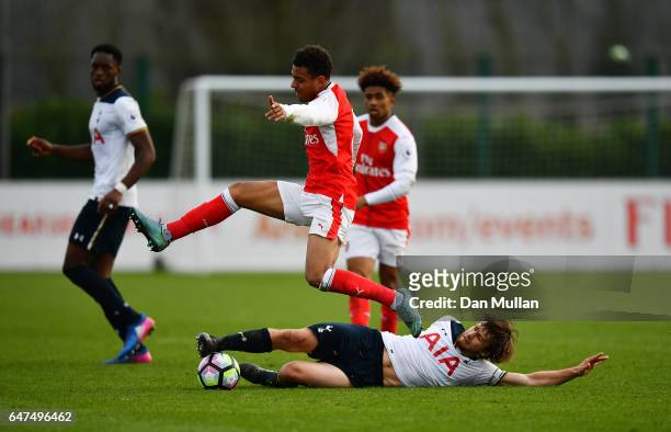 Filip Lesniak of Tottenham Hotspur stretches to tackle Donyell Malen of Arsenal during the Premier League 2 match between Arsenal and Tottenham...