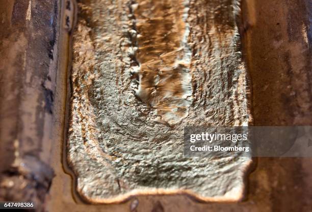 Molten aluminum cools in an ingot mould in the foundry at the Krasnoyarsk aluminum smelter, operated by United Co. Rusal, in Krasnoyarsk, Russia, on...