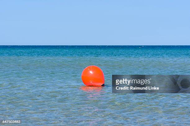 orange buoy in sea - kattegat stock-fotos und bilder
