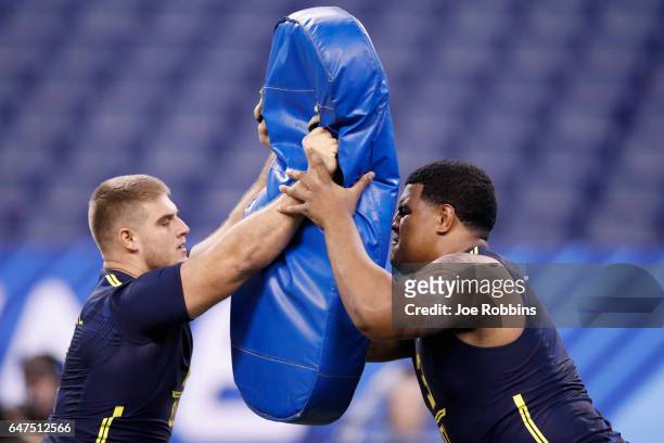Offensive linemen Erik Austell of Charleston Southern and Zach Banner of Southern Cal compete in a blocking drill during the NFL Combine at Lucas Oil...