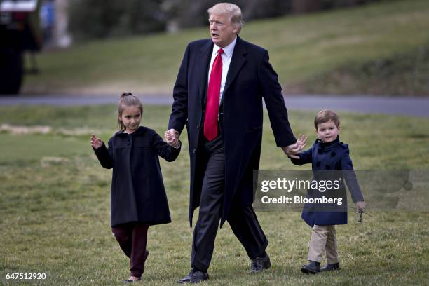 President Donald Trump walks towards Marine One on the South Lawn of the White House with his grandchildren Arabella Kushner, left, and Joseph...