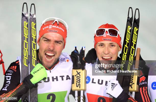 Johannes Rydzek and Eric Frenzel of Germany celebrate winning the gold medal in the Men's Nordic Combined HS130 Ski Jumping / 2 x 7.5km Team Sprint...