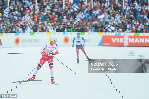 Finn Haagen Krogh from Norway looks back at Russia's Sergey Ustiugov on his way to win Men cross-country 4 x 10.0km Relay Classic/Free final, at FIS...