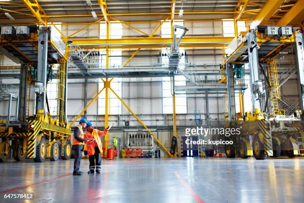 at work on the warehouse floor - crane stock pictures, royalty-free photos & images