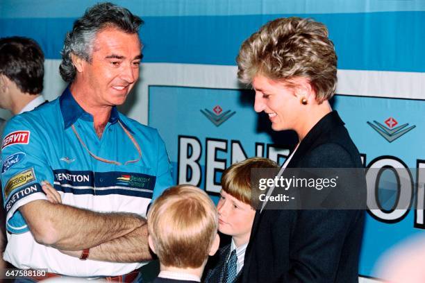 Britain's Princess Diana and her son Harry talk with Italian Flavio Briatore, team manager for the Benetton Ford F-1, during a tour of the pits on...