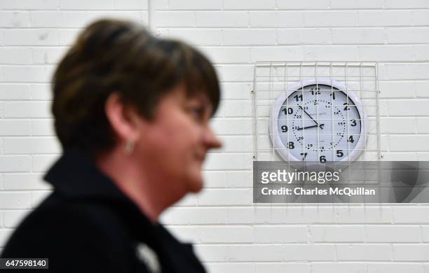 Democratic Unionist party leader and former First Minister Arlene Foster stands under a clock as she waits to make her speech at the Northern Ireland...