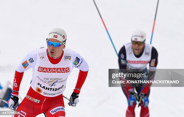 Martin Johnsrud Sundby of Norway and his teammate Finn Haagen Krogh compete during the men's cross-country 4x10 km relay event of the 2017 FIS Nordic...