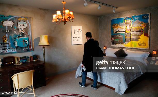 Visitor looks inside a room at street artist Banksy's newly opened Walled Off hotel in the Israeli occupied West Bank town of Bethlehem, on March 3,...