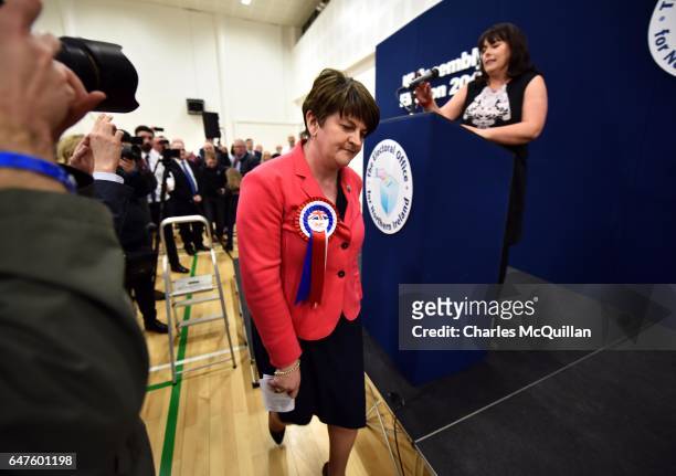 Democratic Unionist party leader and former First Minister Arlene Foster exits the stage after making her speech watched by Michelle Gildernew of...